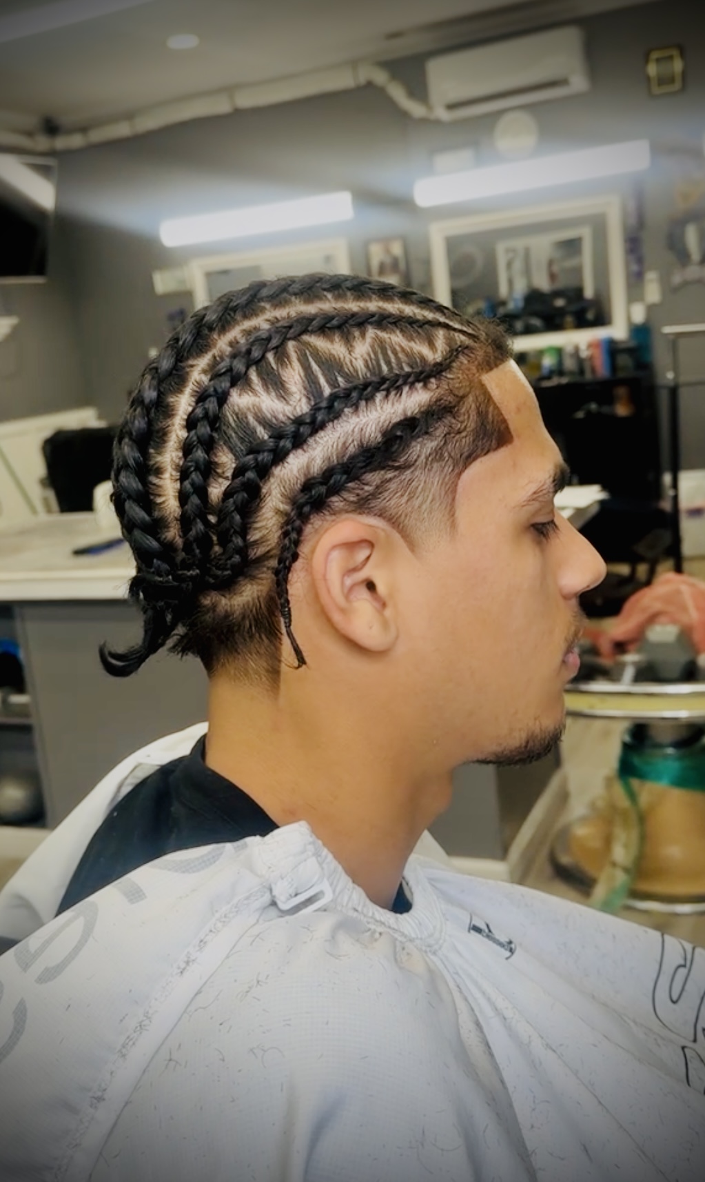 Client with fresh cornrow braids at Teague's Barber Shop